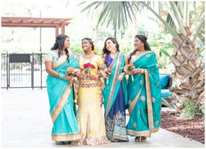 gold and red hindu wedding bridal party