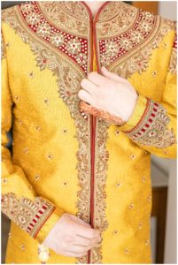 gold and red male wedding attire